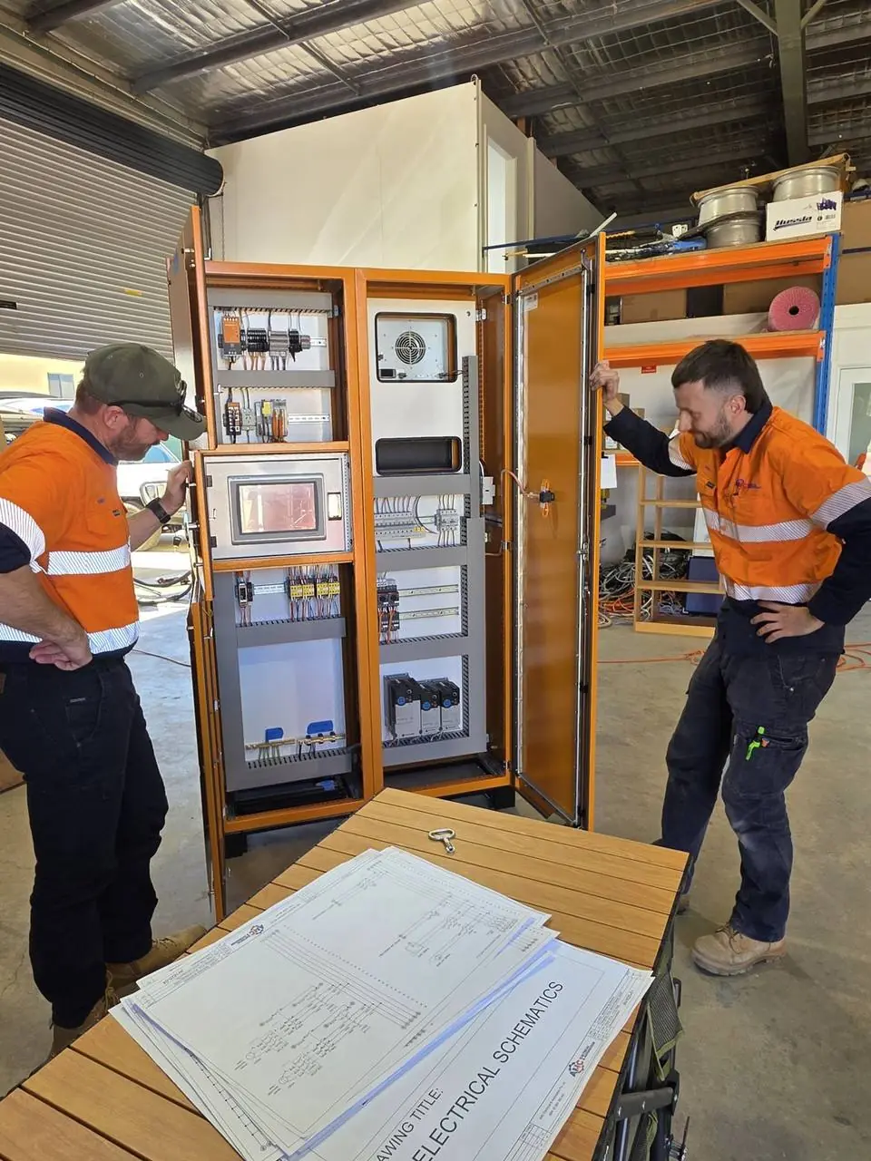 AMC team reviewing a control panel with HMI before delivery