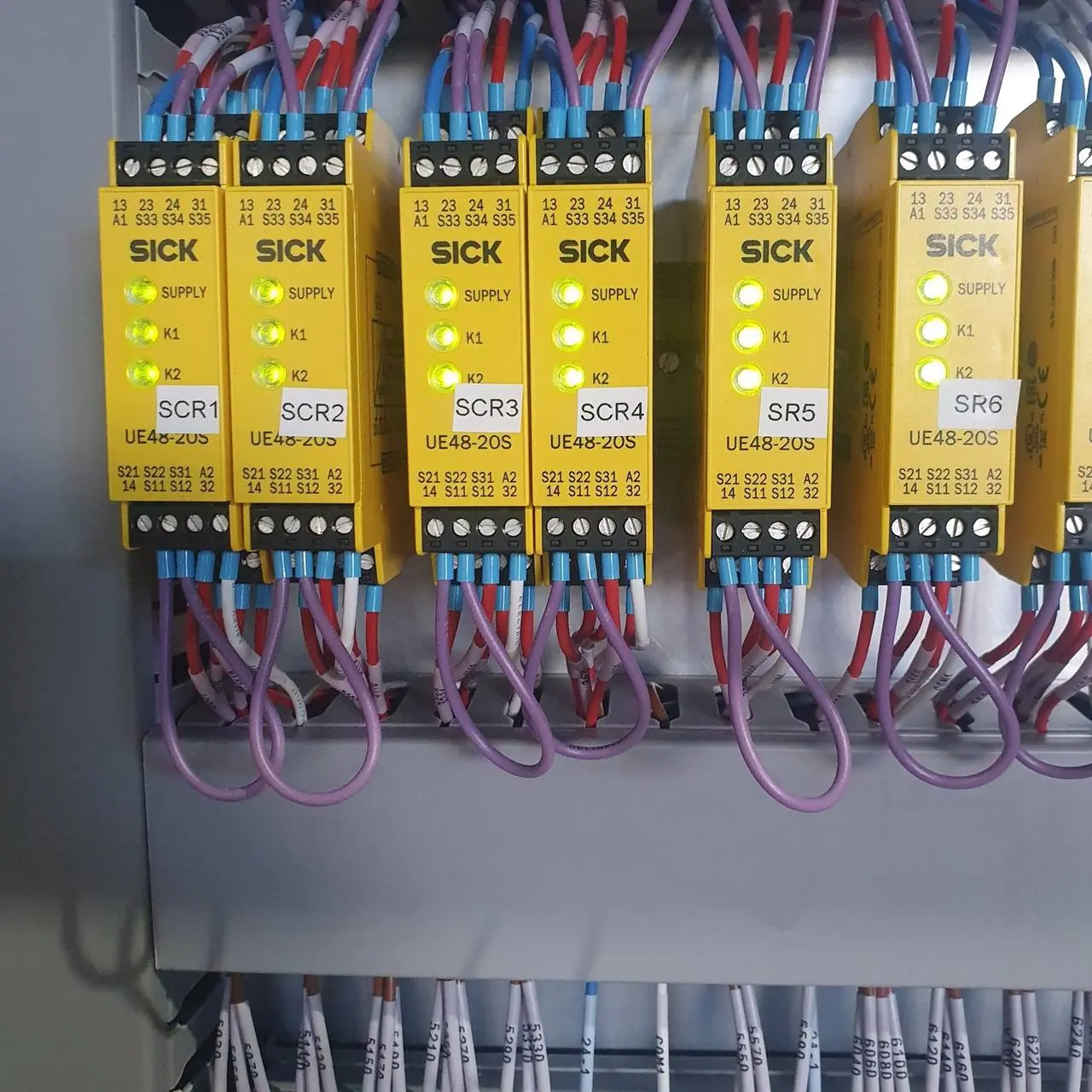 Bank of safety relays in a control panel